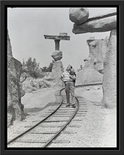 Load image into Gallery viewer, "Walt Walking on the Tracks of Rainbow Caverns Mine Train" from Disney Photo Archives