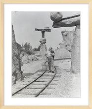 Load image into Gallery viewer, "Walt Walking on the Tracks of Rainbow Caverns Mine Train" from Disney Photo Archives
