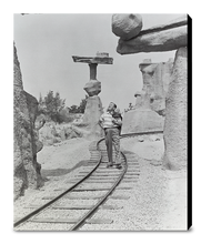 Load image into Gallery viewer, "Walt Walking on the Tracks of Rainbow Caverns Mine Train" from Disney Photo Archives