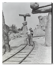 Load image into Gallery viewer, "Walt Walking on the Tracks of Rainbow Caverns Mine Train" from Disney Photo Archives