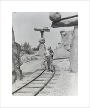 Load image into Gallery viewer, "Walt Walking on the Tracks of Rainbow Caverns Mine Train" from Disney Photo Archives