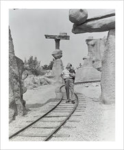 Load image into Gallery viewer, "Walt Walking on the Tracks of Rainbow Caverns Mine Train" from Disney Photo Archives