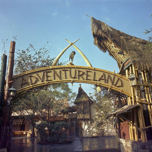 The now iconic Adventureland entrance sign welcomes Guests to the tropical paradise themed area at Disneyland Park, circa 1969.